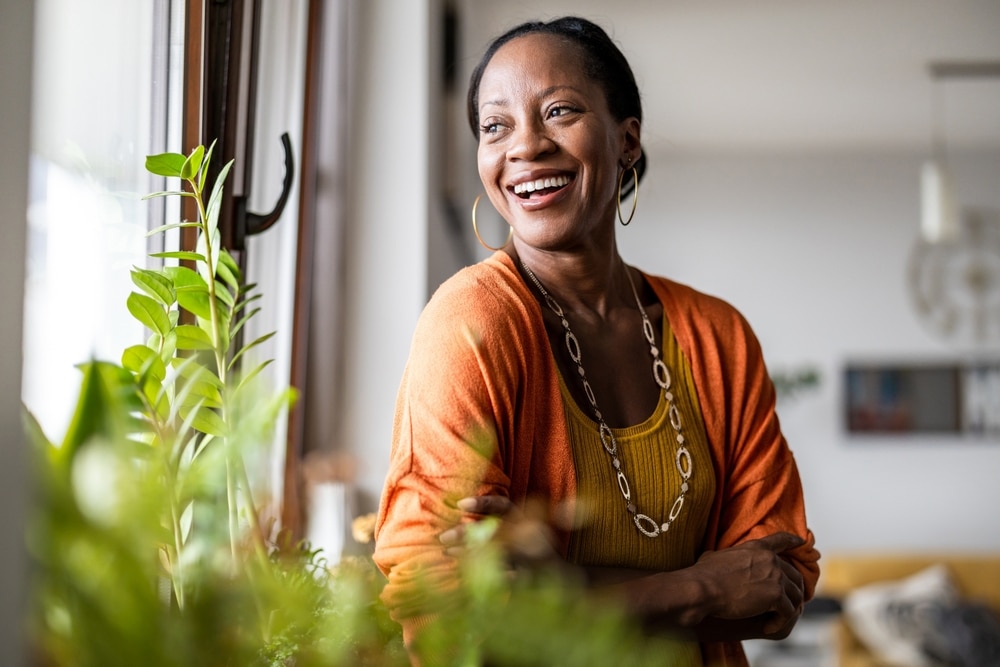 A woman smiles confidently, happy with the results of Dental Bridges at All Valley Dental