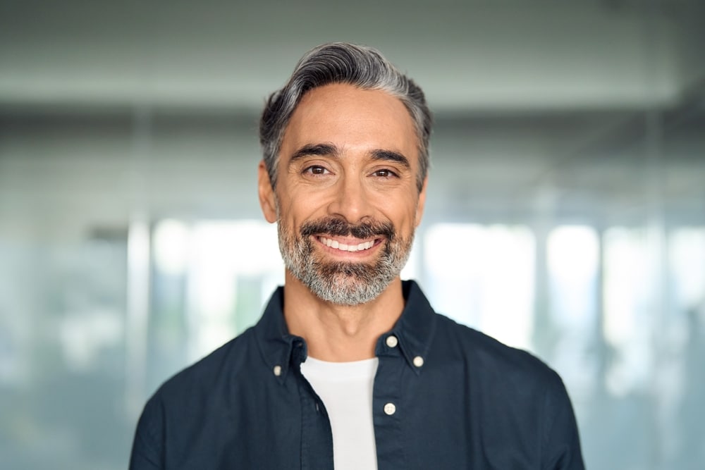 A man is smiling and pain-free thanks to Root Canal Therapy at All Valley Dental